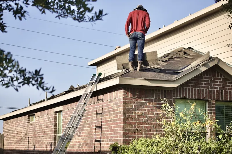 Professional roofer working on a residential roof in Marshfield